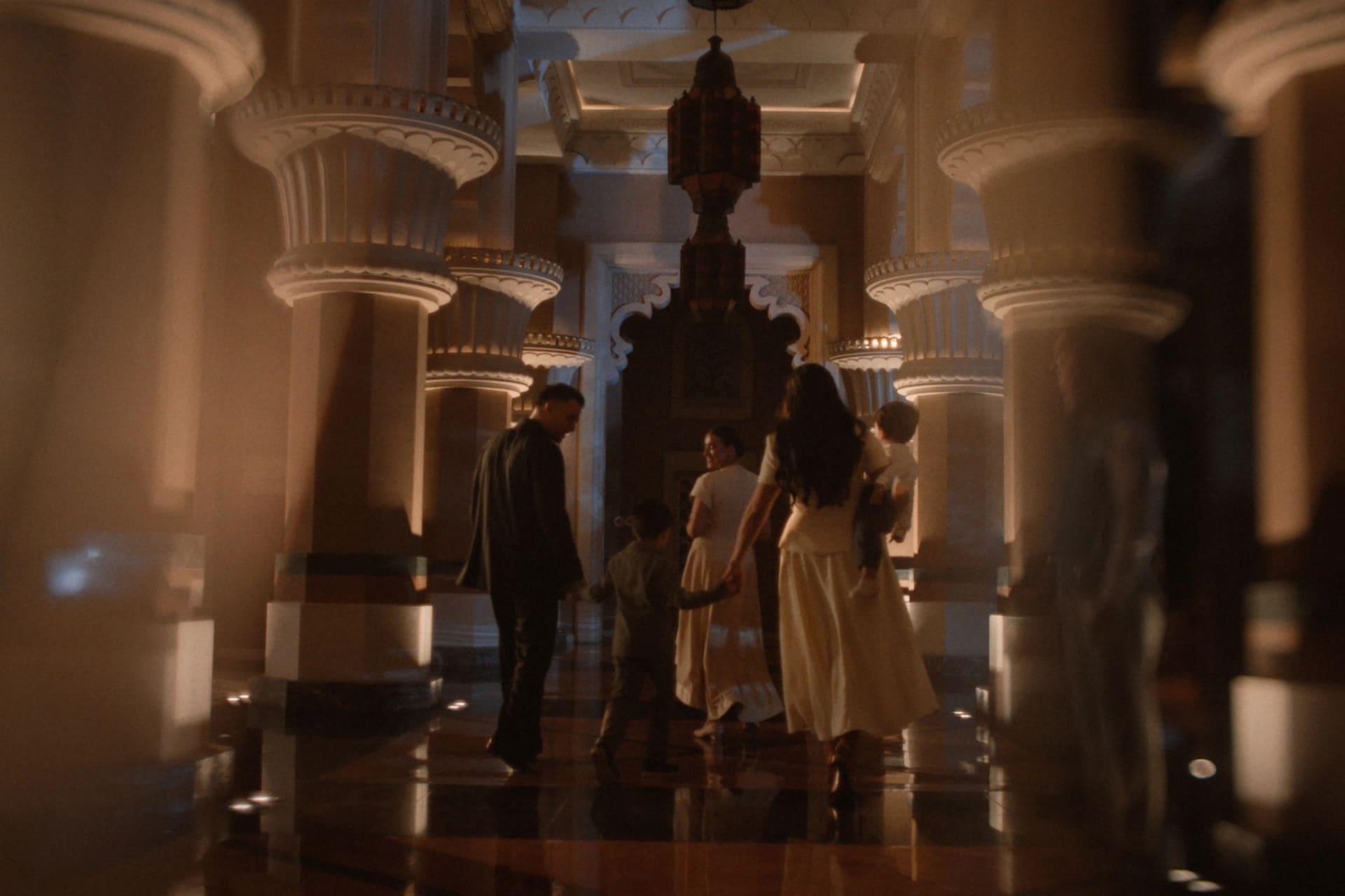 Guests exploring a warmly lit palace interior